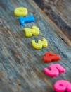 Multicolored numbers for counting on wooden table