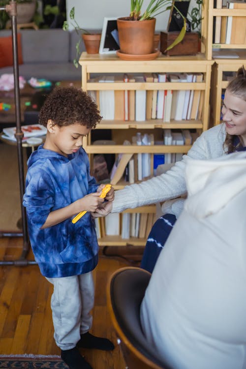 Free Mother giving toy to black son Stock Photo
