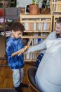Mother giving toy to black son
