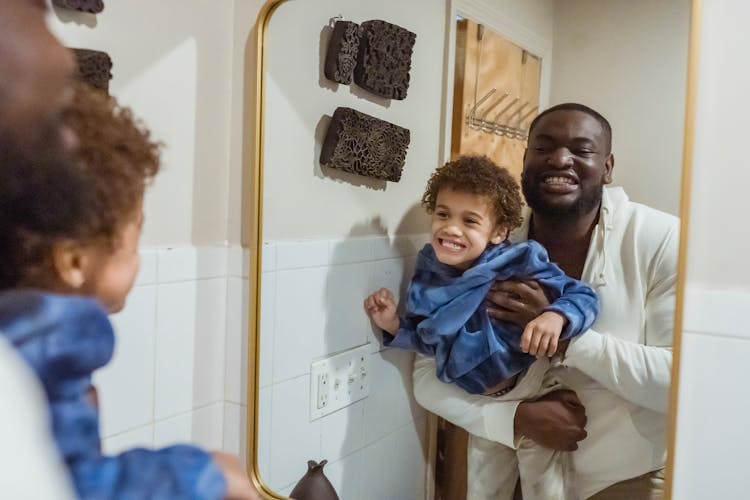 Positive Black Father And Son In Bathroom