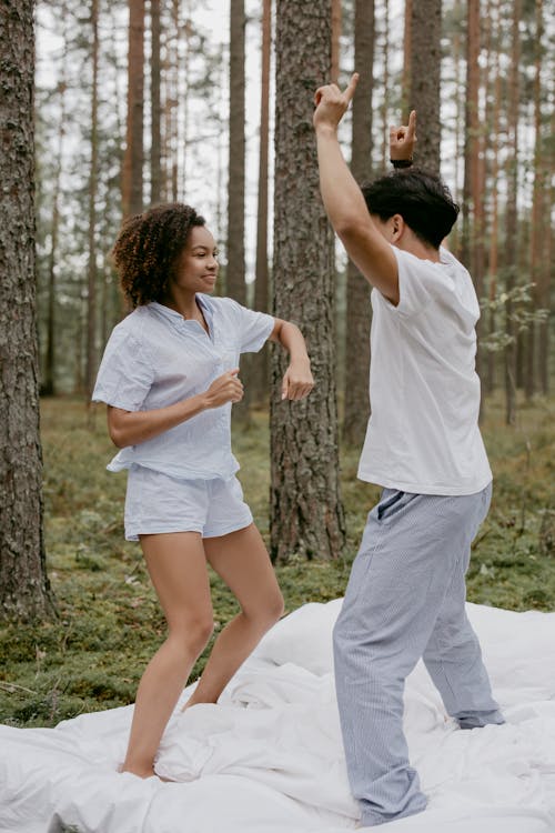 Romantic Couple Dancing on the White Bed