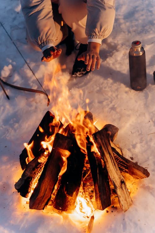 Hands Near a Campfire