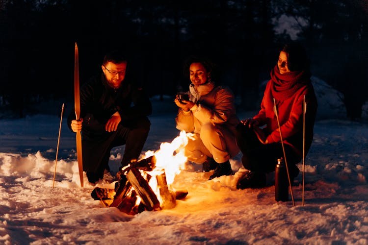 People Sitting Around A Campfire