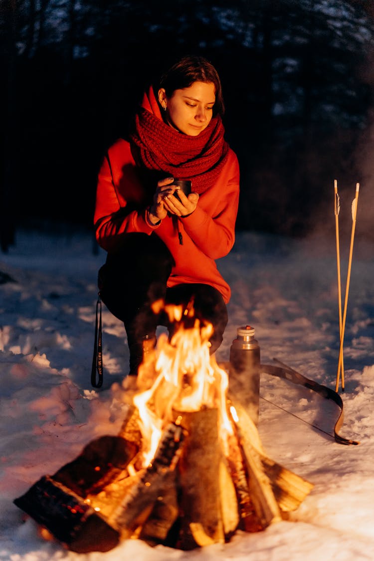 Pretty Woman Sitting Beside A Campfire