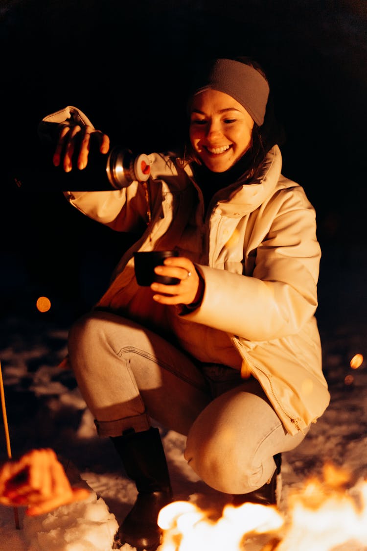 Woman Pouring Coffee In A Cup