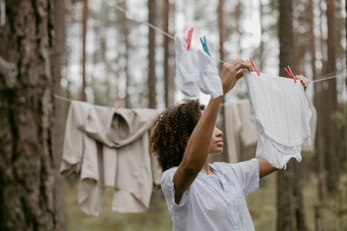 Woman Hanging Laundry Clothes on a Plastic Wire 