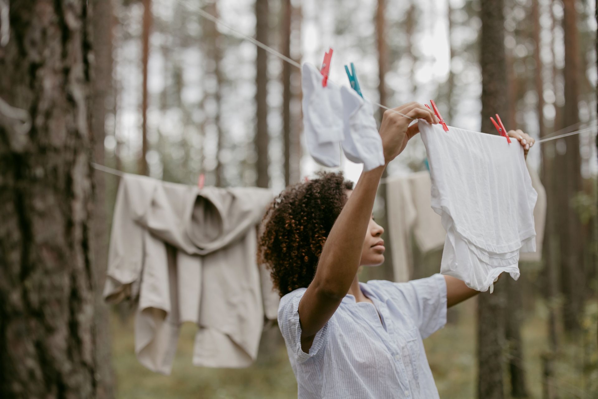 Woman Hanging Laundry Clothes on a Plastic Wire