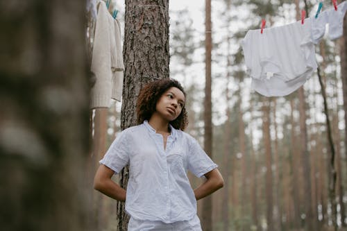 Free Woman in her pajama Leaning on a Tree Stock Photo