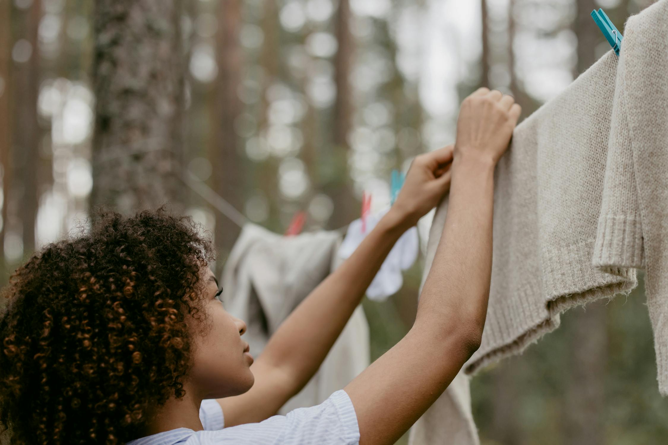 Woman Hanging her Clothes Outside
