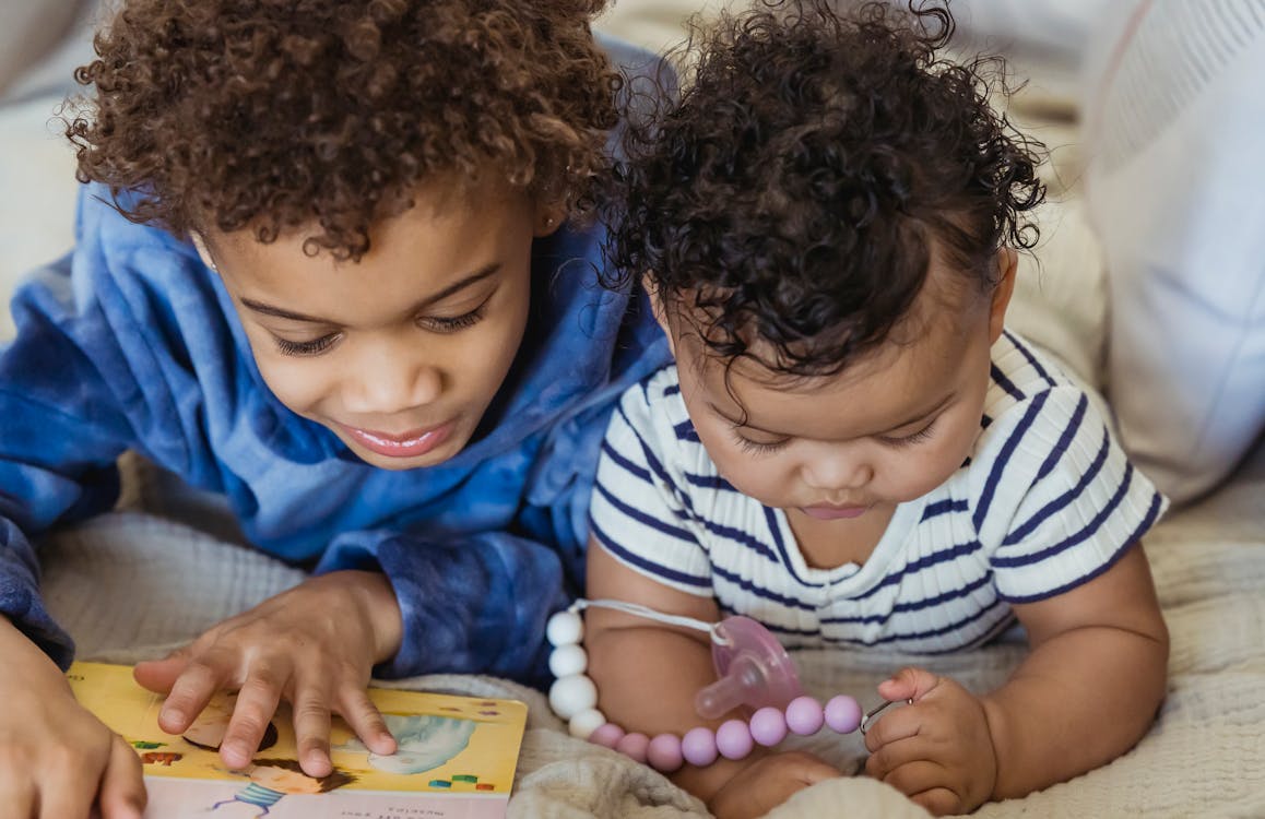 Black children playing on couch