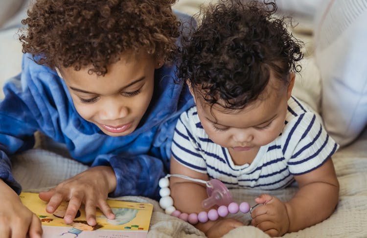 Black Children Playing On Couch