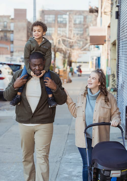 Multiethnic family with stroller walking in walkway