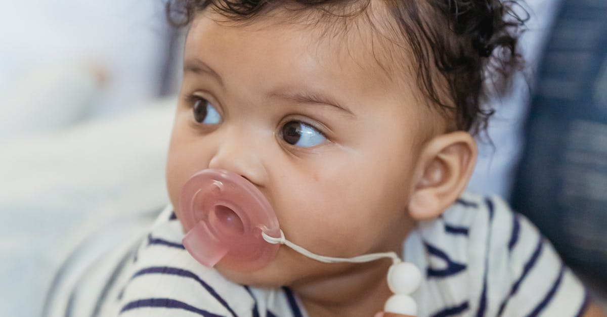 Cute black baby with pacifier · Free Stock Photo