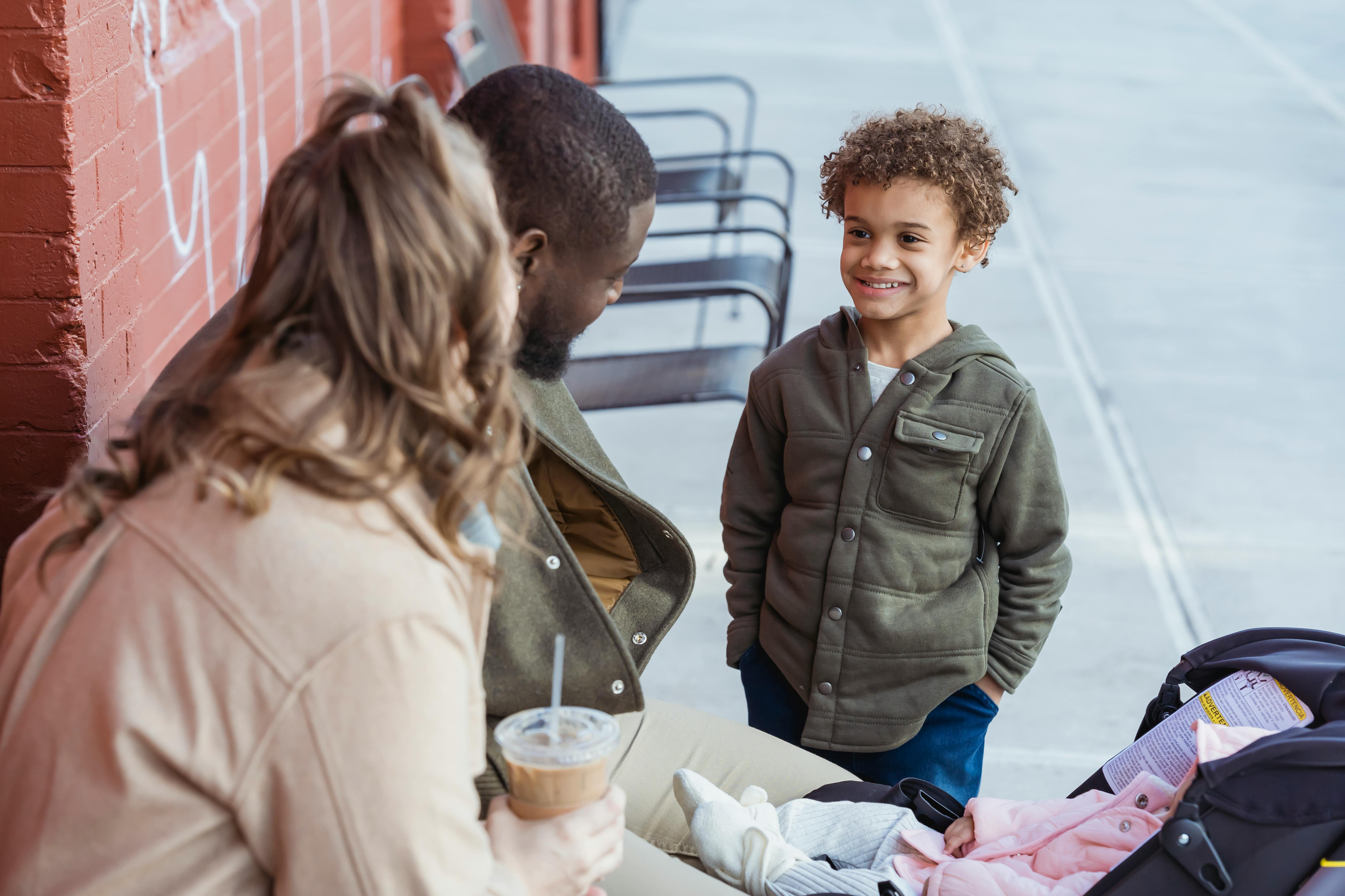 diverse parents near smiling happy black son