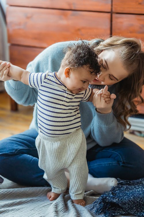 Free Happy mother learning black baby walking Stock Photo