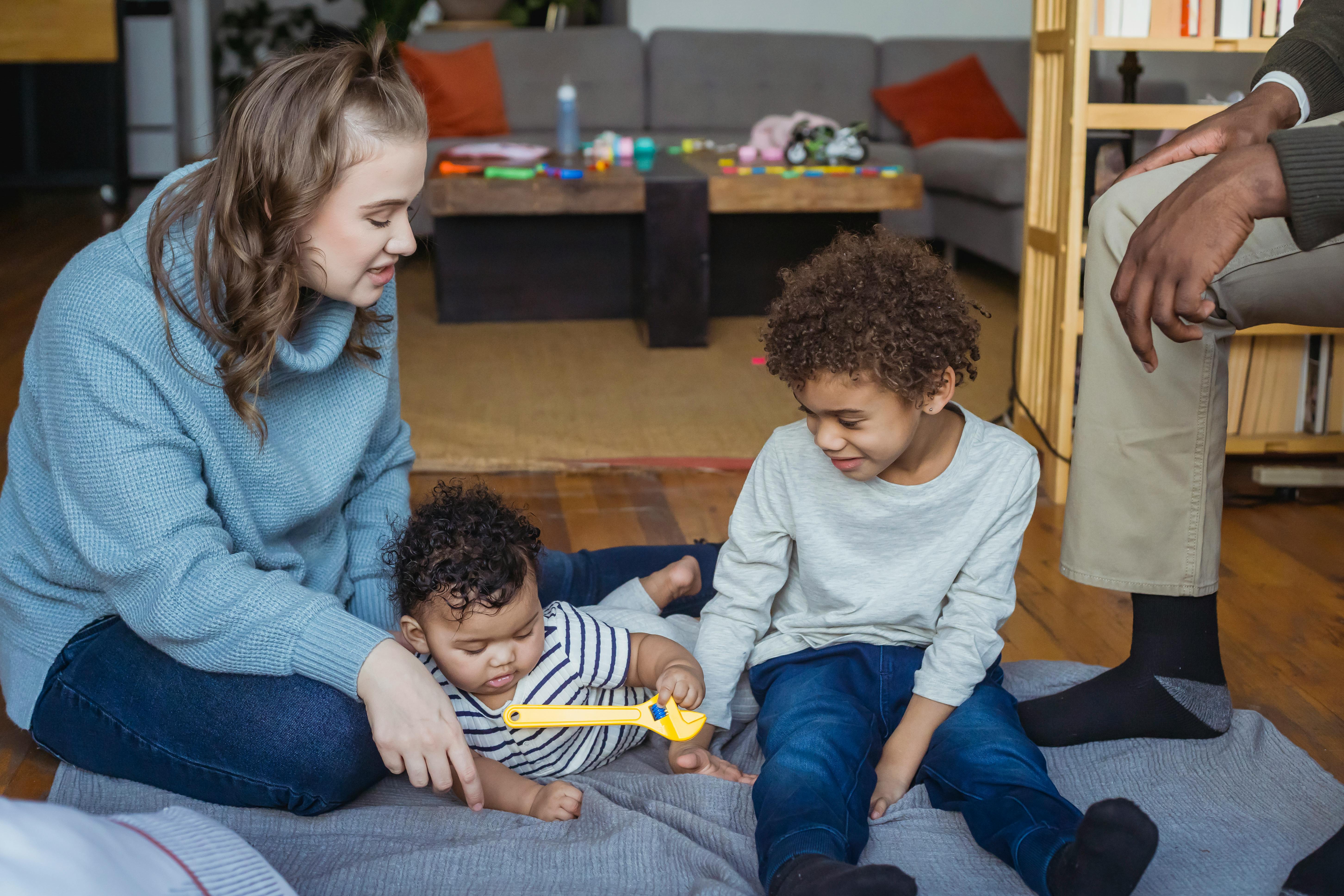 mother and black son playing with baby