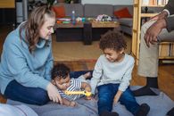 Mother and black son playing with baby