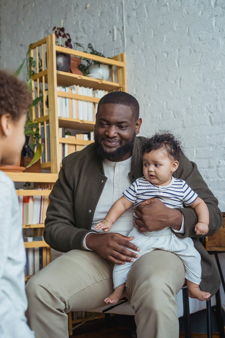 Black Father With Baby On Knees