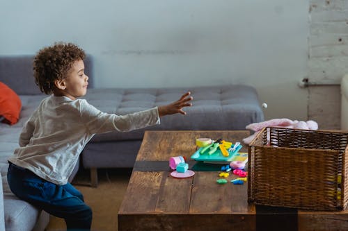 Ethnic boy reaching out to braided box