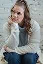 Young woman supporting head with hand and looking away