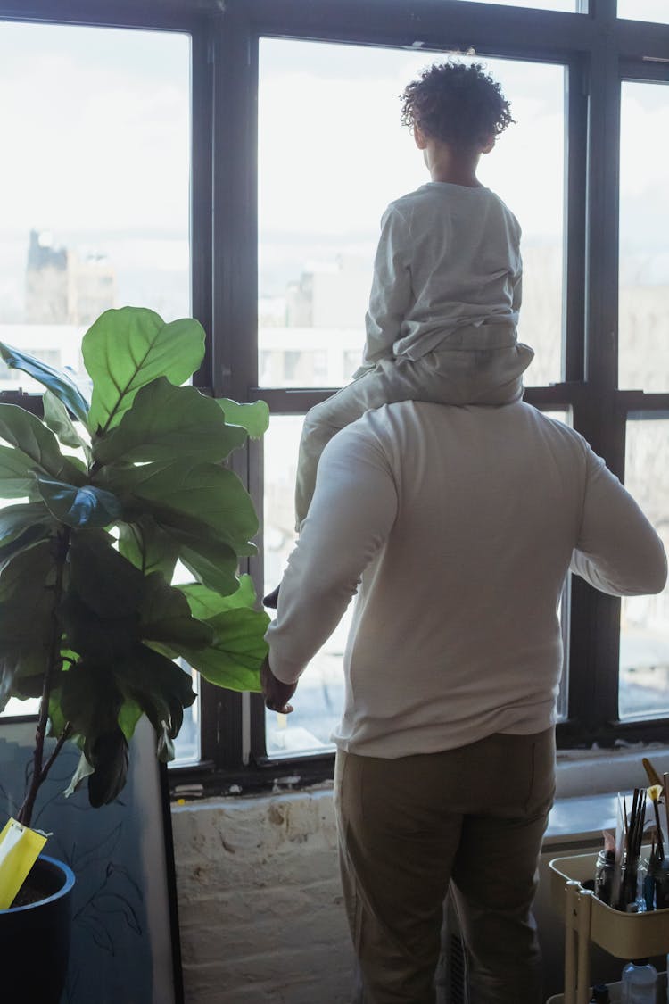 Unrecognizable Man With Son On Shoulders