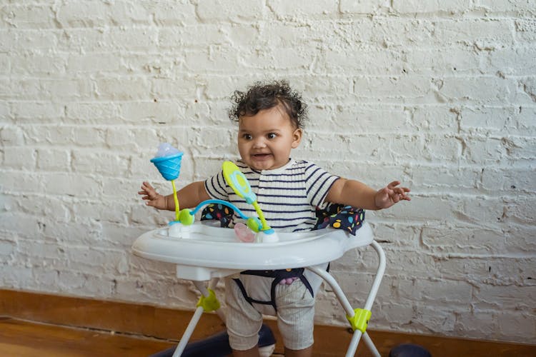 Happy Black Baby In Walker