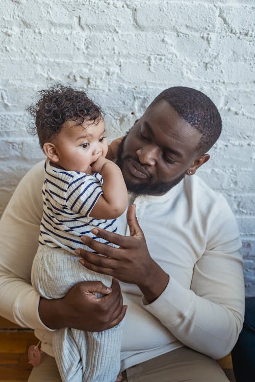 Loving black father with toddler
