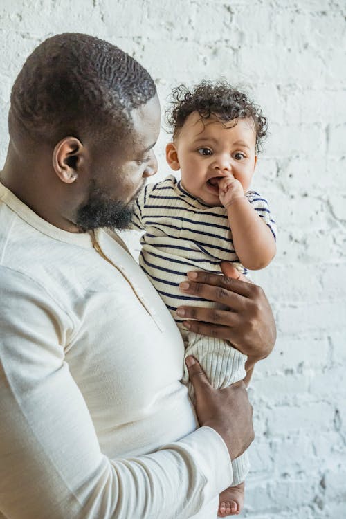 Caring black father with baby