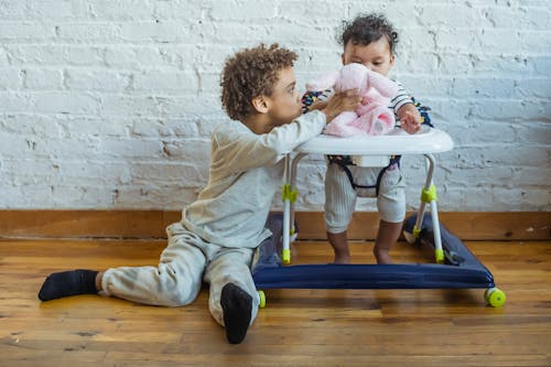 Free Black siblings playing in room Stock Photo