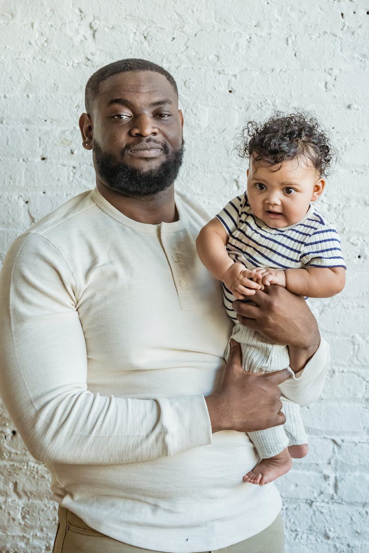 African American Father With Baby On Hands