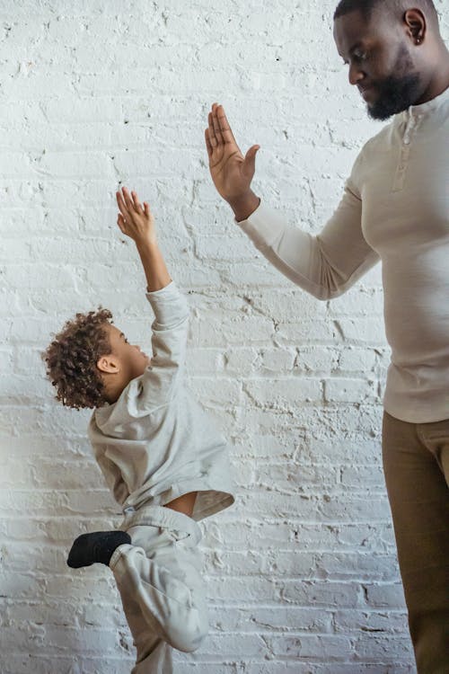 Free Black father and son doing high five Stock Photo
