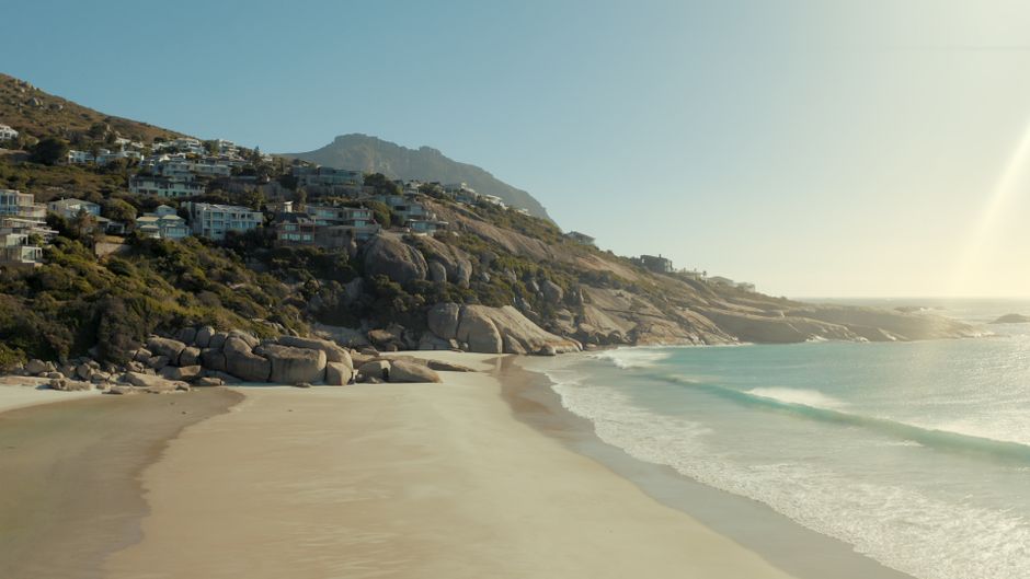People enjoying a sunny summer beach day in Cape Town, South Africa