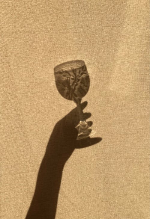 Shadow of Woman Hand Holding Glass