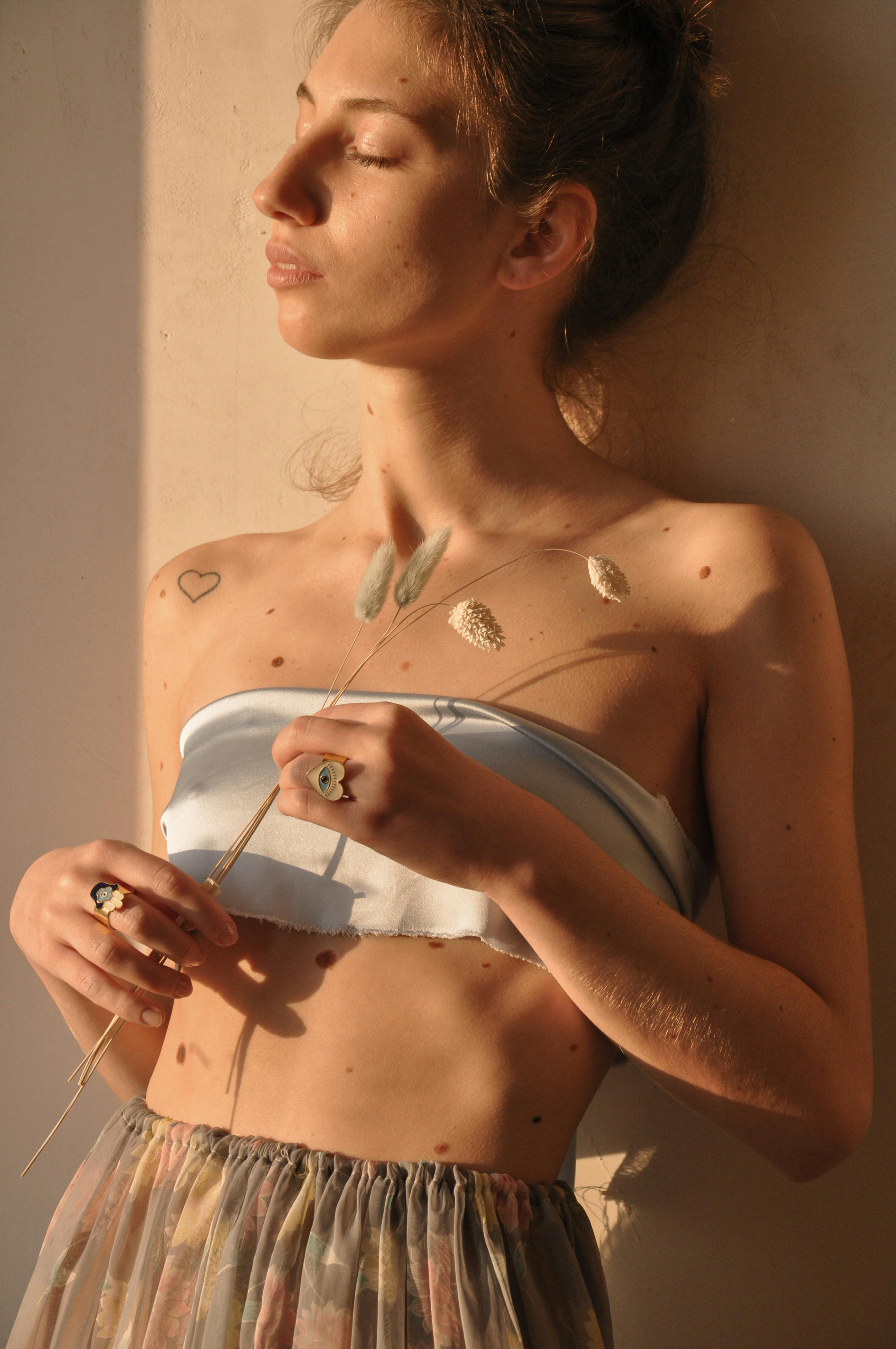 peaceful woman with dried branch under sunlight