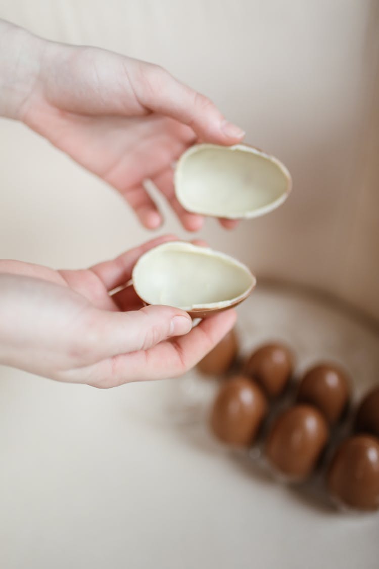 Person Holding Egg Shape Chocolate