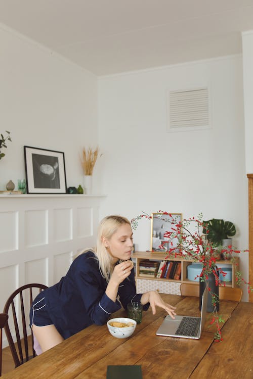 Woman in Blue Pajama Using a Laptop