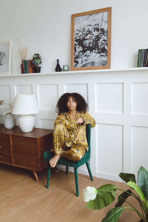 Free Woman Sitting on Green Chair Stock Photo