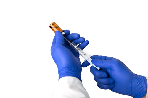 Crop doctor drawing medicine into syringe