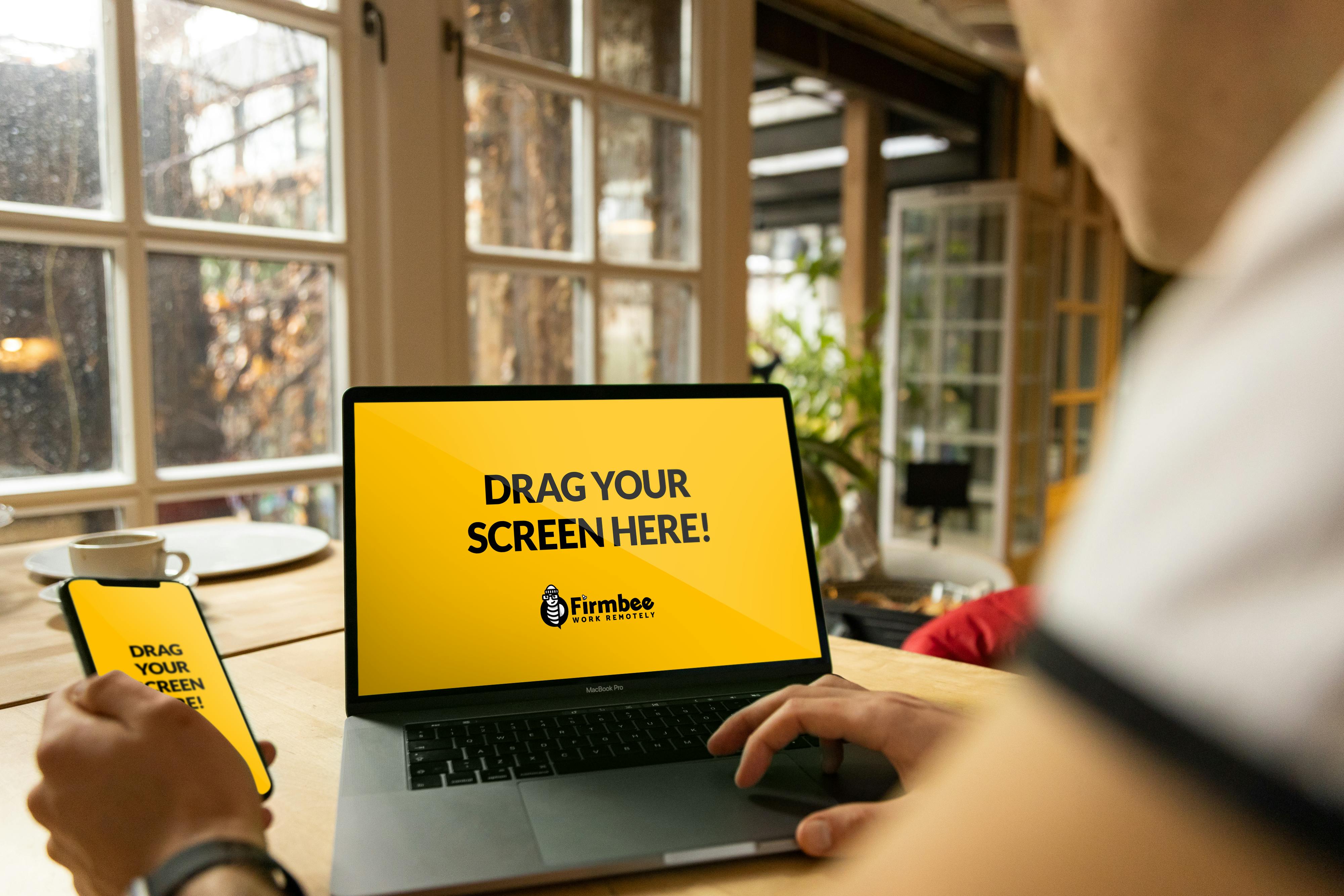 person using macbook pro on table