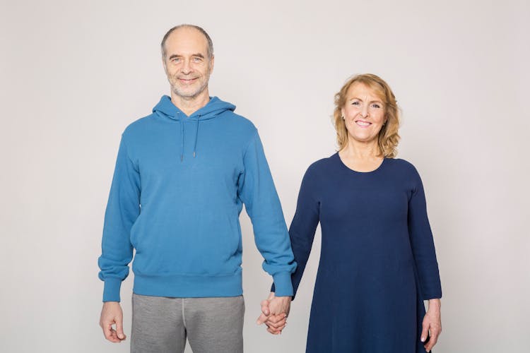 Man In Blue Jacket Beside Woman In Blue Dress