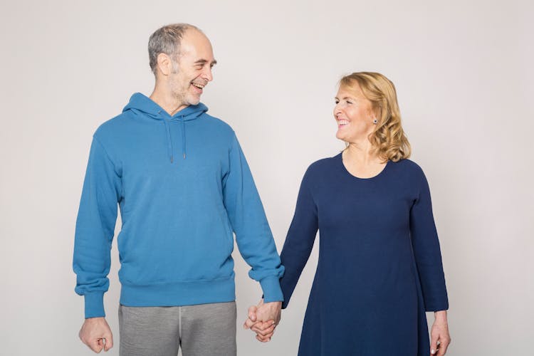 Man In Blue Jacket Beside Woman In Blue Dress