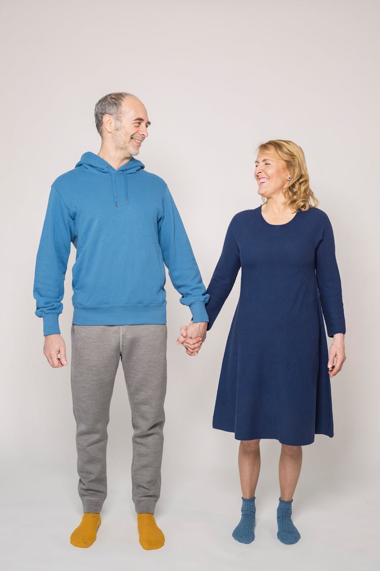 Man In Blue Long Sleeve Shirt Beside Woman In Blue Dress