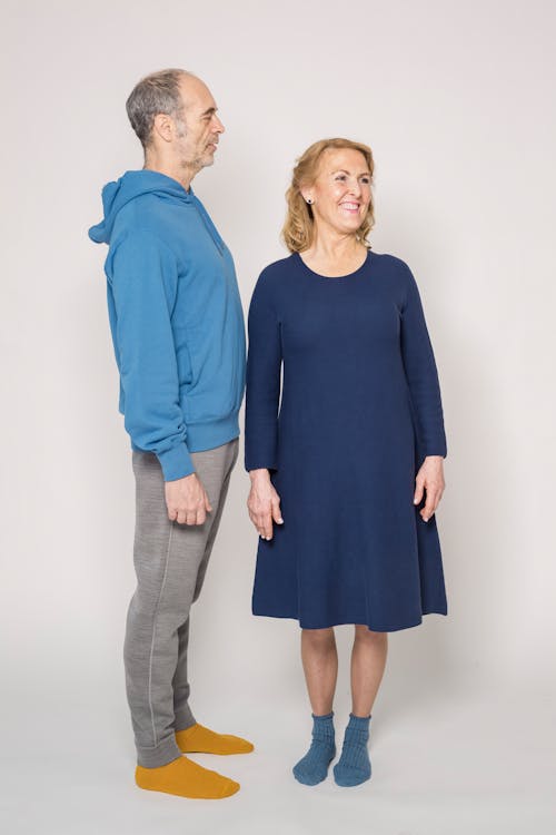 Woman in Blue Dress Beside Man in Blue Long Sleeve Shirt