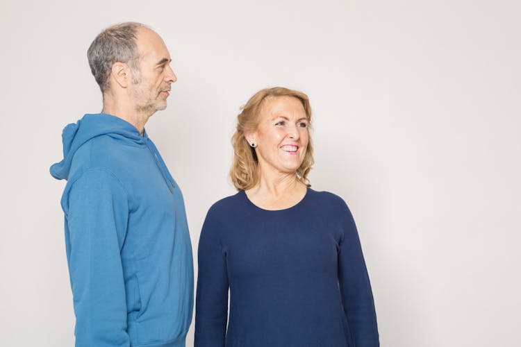 Man In Blue Long Sleeve Shirt Beside Woman In Blue Long Sleeve Shirt