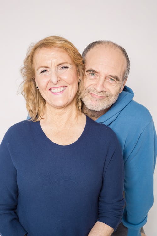 Man in Blue Jacket and Woman in Blue Long Sleeve Shirt