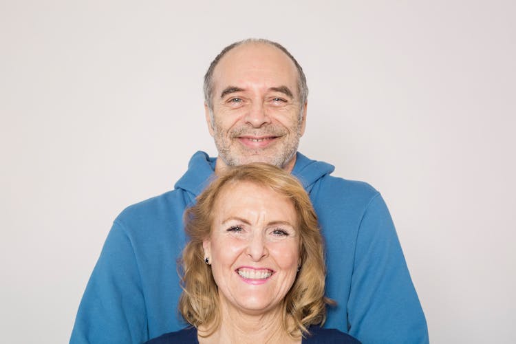 Man In Blue Jacket And Woman In Blue Shirt