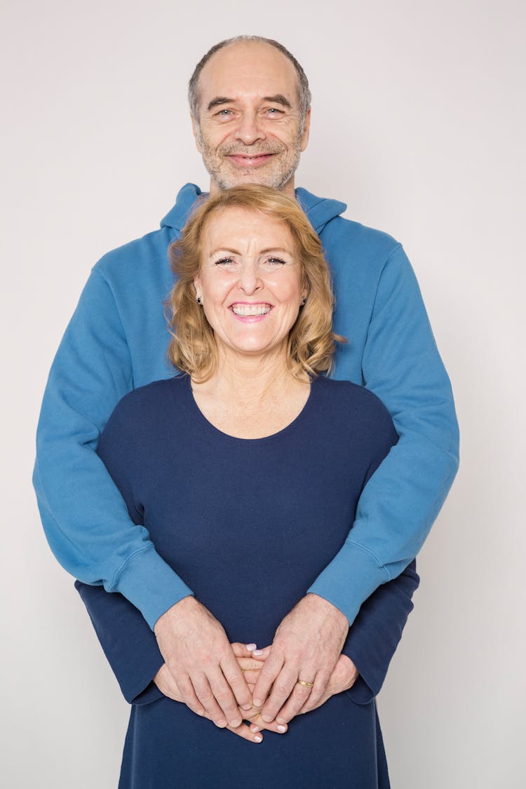 Man In Blue Jacket With Woman In Blue Shirt