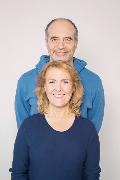 Free Man in Blue Jacket Beside Woman in Blue Shirt Stock Photo