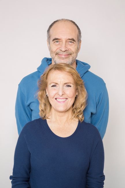 Elderly couple smiling in a bright studio setting. Capturing joy and love indoors.