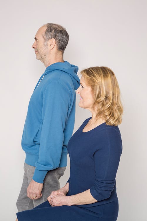 Man in Blue Jacket Beside Woman in Blue Shirt